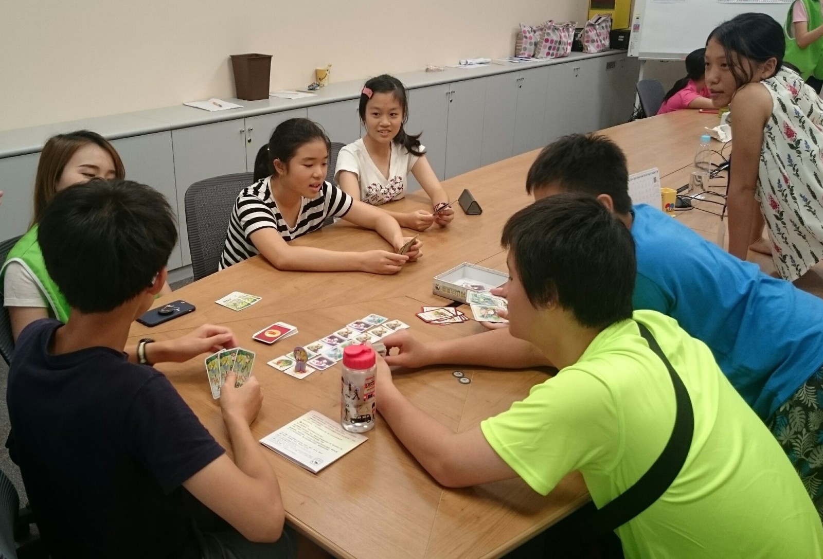 Teenagers played board game <Mystic Mountains Adventures>,  while applying communication skills they just learned.